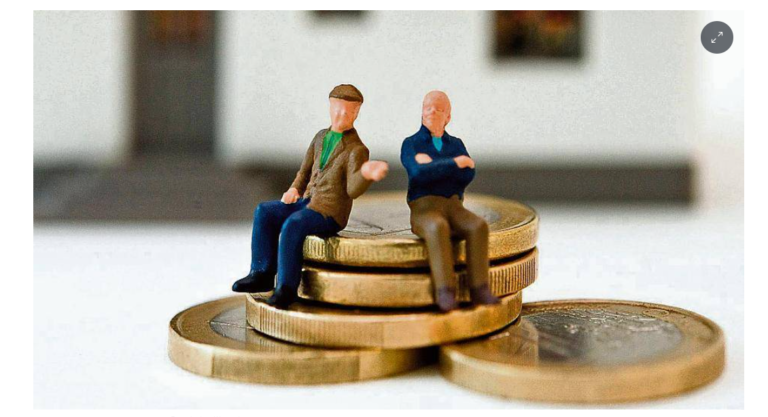 Two little men in the shape of elderly men sit on 1 euro coins